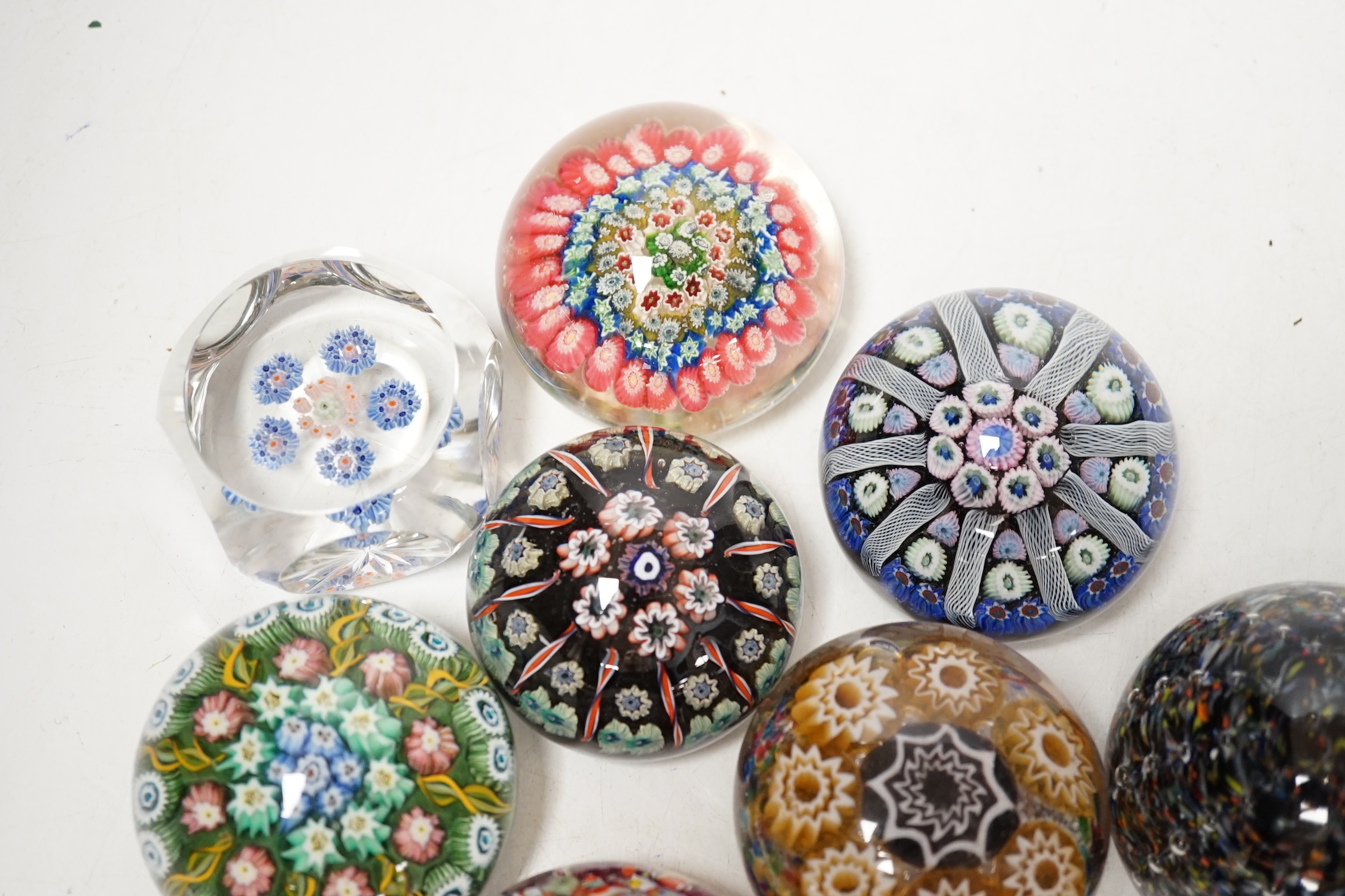 Eight millefiori or scrambled glass paperweights including Strathearn, largest 6cm in diameter